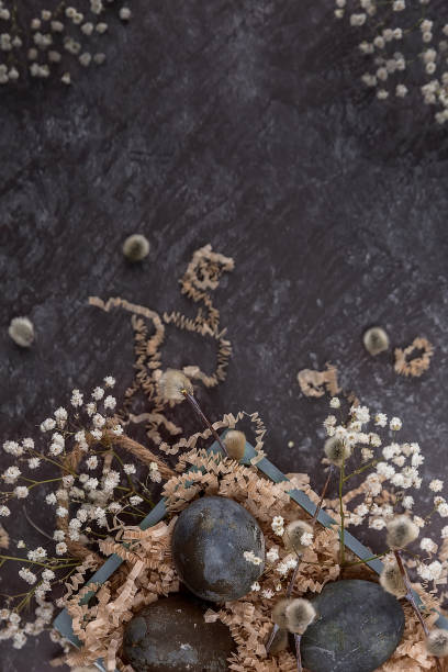 istock Easter composition with dark colored eggs in a wooden box. Willow branch. The minimal concept of Easter. 1314996881