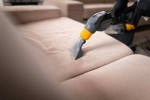 Man vacuuming a sofa in the living room Sofa cleaning by a device. Close-up of housekeeper hand holding modern washing vacuum cleaner and cleaning dirty sofa with professionally detergent. leather care stock pictures, royalty-free photos & images