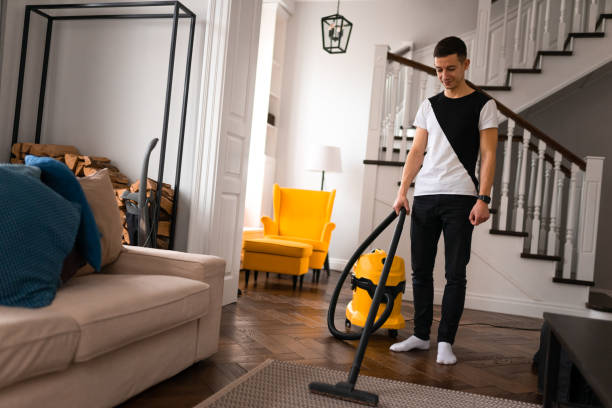 istock Man doing vacuum cleaning in room. 1315004987