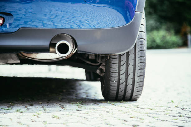 Powerful car with exhaust pipe, pollution and fine dust Close up of an exhaust pipe of a car, environmental pollution exhaust pipe photos stock pictures, royalty-free photos & images