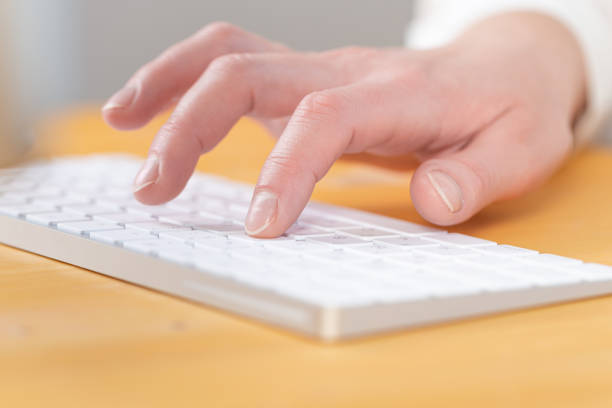 istock Woman office worker typing on white keyboard 1315011088