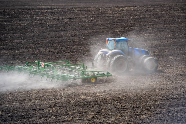istock tillage in the field with a tractor with a trailed machine 1315014725