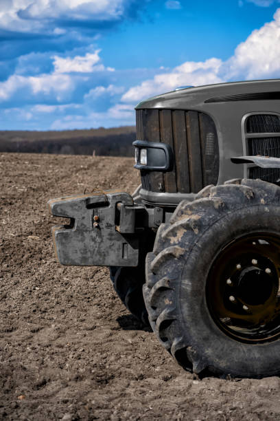 istock old tractor on the field against the sky 1315014858