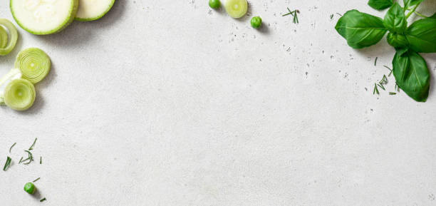 Zucchini, basil, peas, leek and dill on a concrete background.