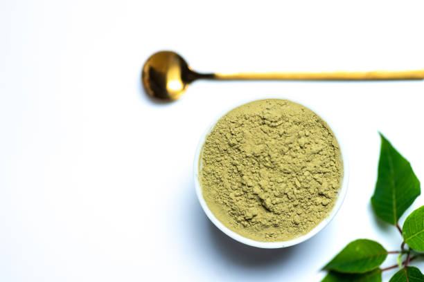 Matcha tea powder with spoon on white background Matcha tea powder in a bowl with spoon on white background and copy space. green tea powder stock pictures, royalty-free photos & images