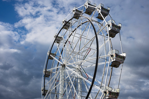 Portland, OR, USA - Apr 25, 2021: The antique Ferris Wheel in Portland's Oaks Amusement Park that reopens in compliance with COVID mandates during a pandemic springtime.
