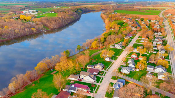 istock Riverside neighborhood with clouds reflecting in water surface 1315023045