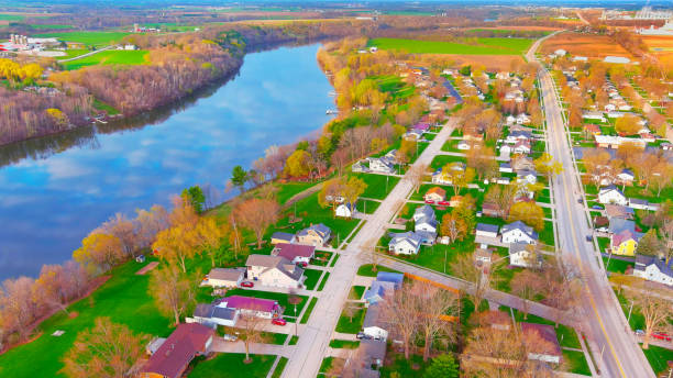 istock Riverside neighborhood with clouds reflecting in water surface 1315023665