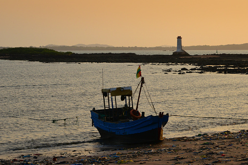 Conakry, Guinea: Boulbinet artisanal fishing port, beached fishing boat and the old lighthouse - Port Boulbinet