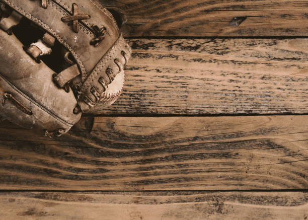 istock Old baseball glove on wood background 1315025026