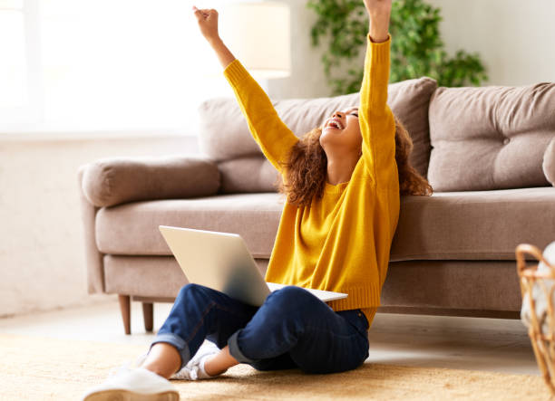 istock Happy african american female celebrating success while working 1315025540