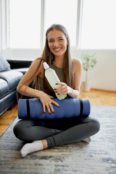 istock Woman drinking water after intensive home workout 1315026588