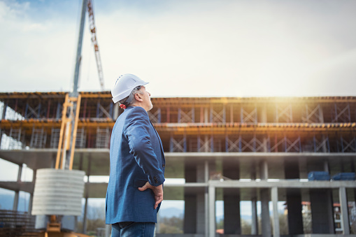 Side view of an entrepreneur looking at construction site.