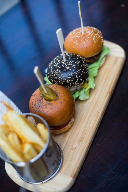 istock Three mini burgers and fries 1315028705