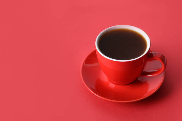 istock Red cup of coffee on red background. Copy space 1315028731