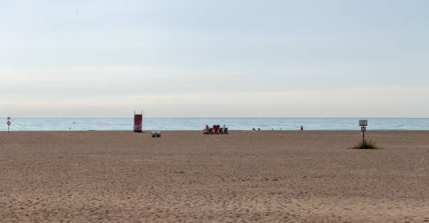 istock Chairs overlooking the lake on a sandy beach 1315029812