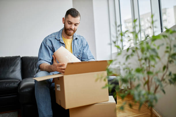 istock A man is packing and unpacking as he is moving into a new house 1315030247