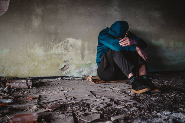 istock Drug addict with syringe in an abandoned place 1315030256