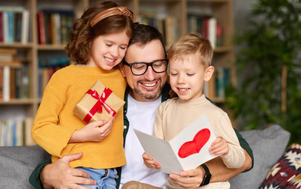 istock Cute children congratulating happy daddy with Fathers day and gi 1315030284
