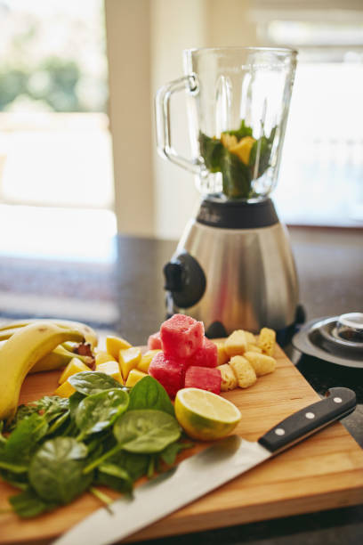 istock Closeup shot of freshly cut fruit and a blender on a kitchen counter 1315030359