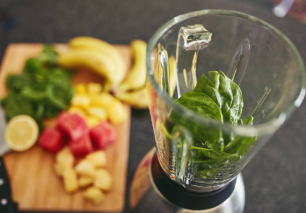 istock High angle shot of a blender filled with spinach alongside freshly cut fruit on a kitchen counter 1315030360