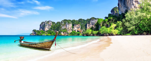 Panorama of thai traditional wooden longtail boat and beautiful sand beach. Thai traditional wooden longtail boat and beautiful sand Railay Beach in Krabi province. Ao Nang, Thailand. koh poda stock pictures, royalty-free photos & images