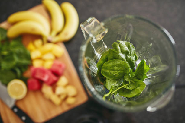 istock High angle shot of a blender filled with spinach alongside freshly cut fruit on a kitchen counter 1315030442