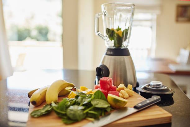 istock Closeup shot of freshly cut fruit and a blender on a kitchen counter 1315030444