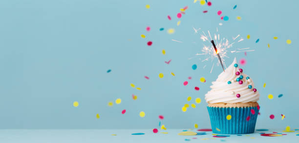 birthday cupcake with sparkler and falling confetti - cupcake imagens e fotografias de stock
