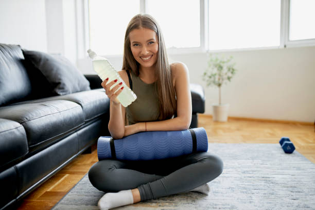 istock Woman drinking water after intensive home workout 1315032477