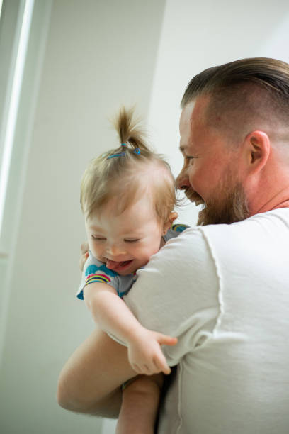 a little baby with your father at home