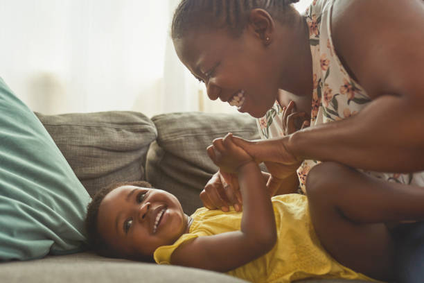 foto de una mujer que se une a su hija en su casa - playing playful baby contemporary fotografías e imágenes de stock