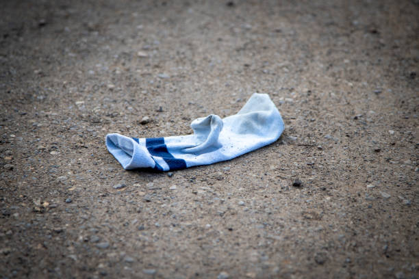 sock that someone lost on a gravel path