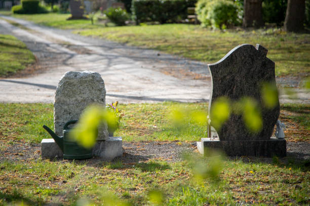 two tombstones on a grave yard, backview, focus on stones