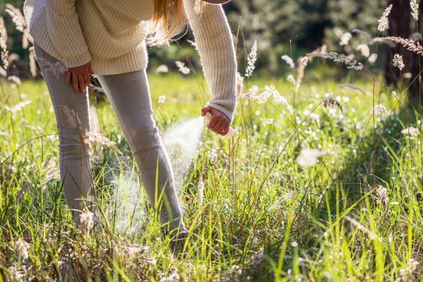 istock Woman spray insect repellant against tick 1315037471