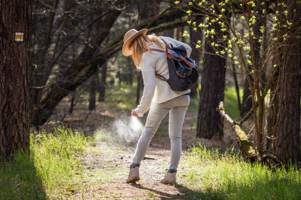 istock Hiker applying insect repellant during hike in forest 1315037987