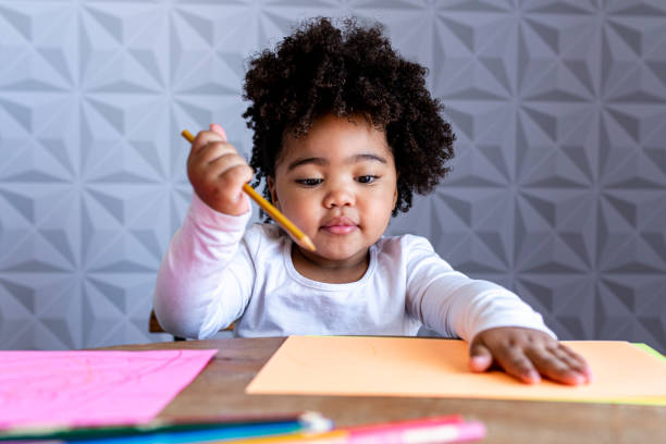 istock Child with colored pencils and colored papers for drawing 1315038058
