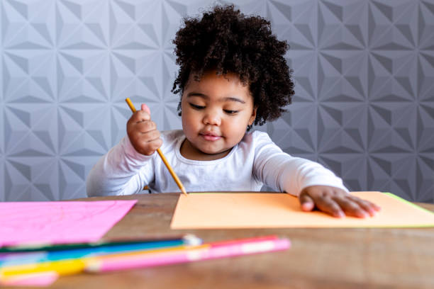 istock Girl concentrated on drawing on colored papers 1315038087