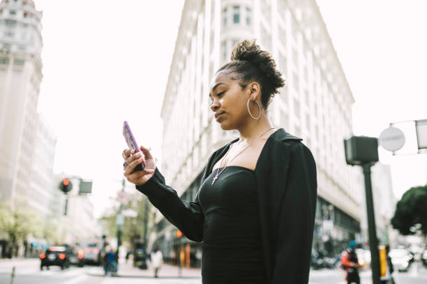 istock Young woman using smartphone in the city 1315040173
