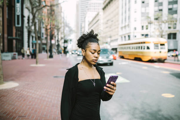 istock Young woman using smartphone in the city 1315040175