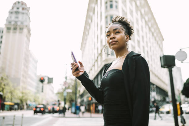 istock Young woman using smartphone in the city 1315040184