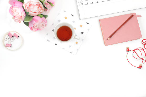 istock Modern woman working desk, home office. Computer, a cup of tea and spring flowers on a light table. Business minimal concept, home comfort, top view, flat lay, place for text, 1315043799