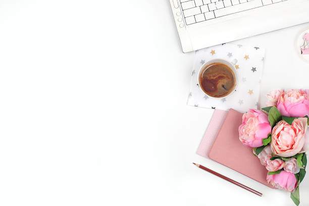 istock Modern woman working desk, home office. Computer, a cup of coffee and spring flowers on a light table. Business minimal concept, home comfort, top view, flat lay, place for text, 1315043833