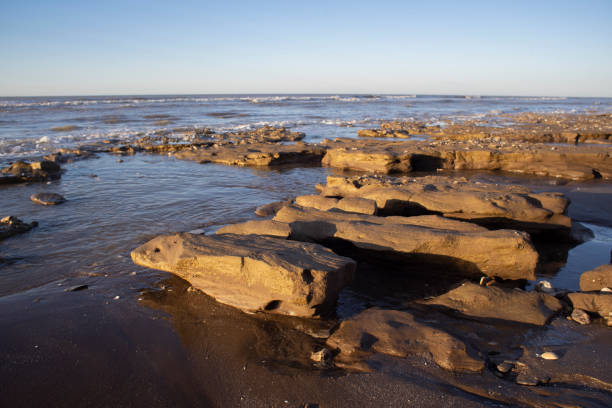 istock rock formation on a beach in the Atlantic Ocean. Warm light. 1315046057
