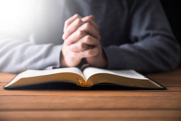 istock prayer man with Holy Bible 1315047312