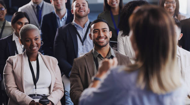 shot of a group of businesspeople attending a conference - attending imagens e fotografias de stock