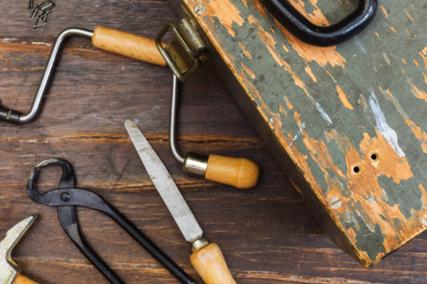 istock Vintage wooden tool box, close-up. On a dark rough background, carpentry tools in the background. Selective focus. 1315049493