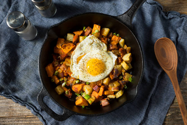 Homemade Healthy Sweet Potato Hash Homemade Healthy Sweet Potato Hash with Fried Eggs sweet potato stock pictures, royalty-free photos & images