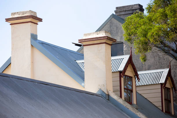 Rooftops of old houses with chimney, background with copy spacw Rooftops of old houses with chimney, background with copy space, full frame horizontal composition australia house home interior housing development stock pictures, royalty-free photos & images