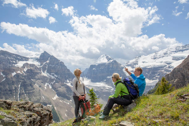 istock Hikers relax on grassy mountain slope in the morning 1315051538